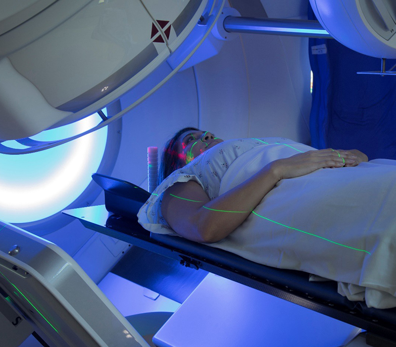 patient lying on back on radiation table for cancer therapy