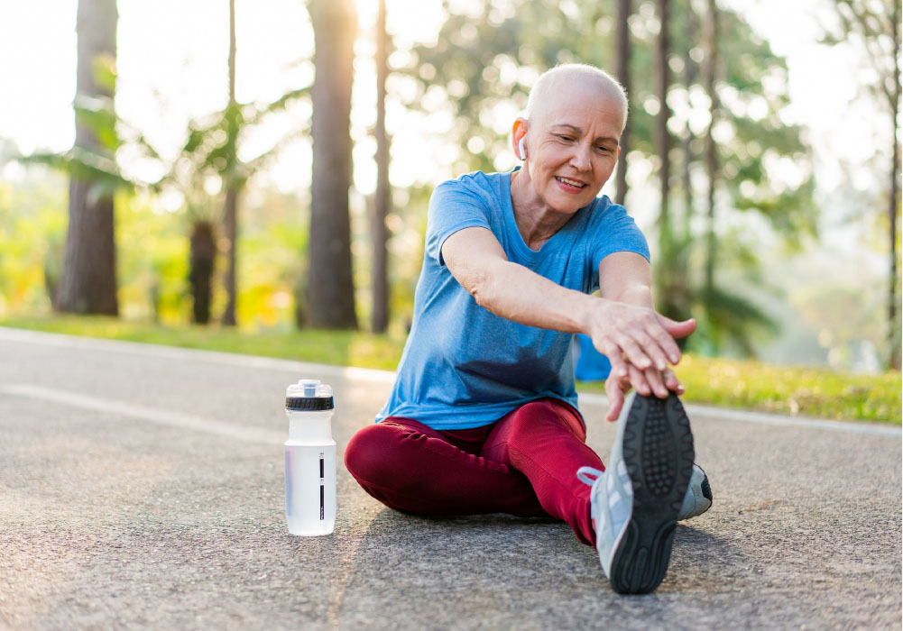 Woman with alopecia stretching on a walking trail