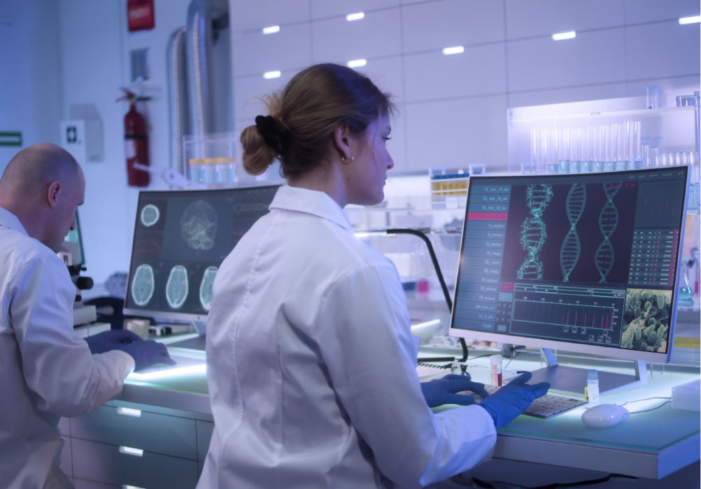 Lab technicians with computer screens showing brain scans and DNA profiles